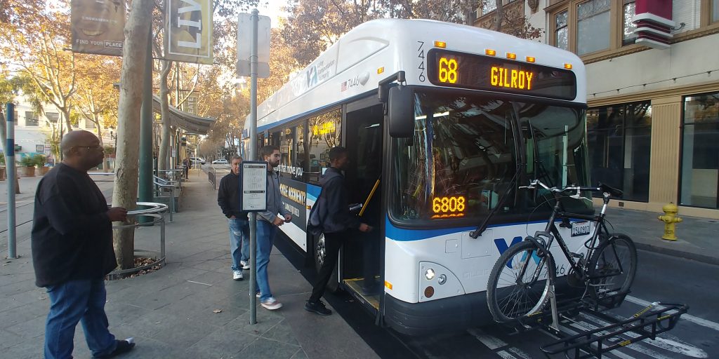 Passengers boarding a white and blue VTA 68 bus heading to Gilroy, in downtown San Jose.