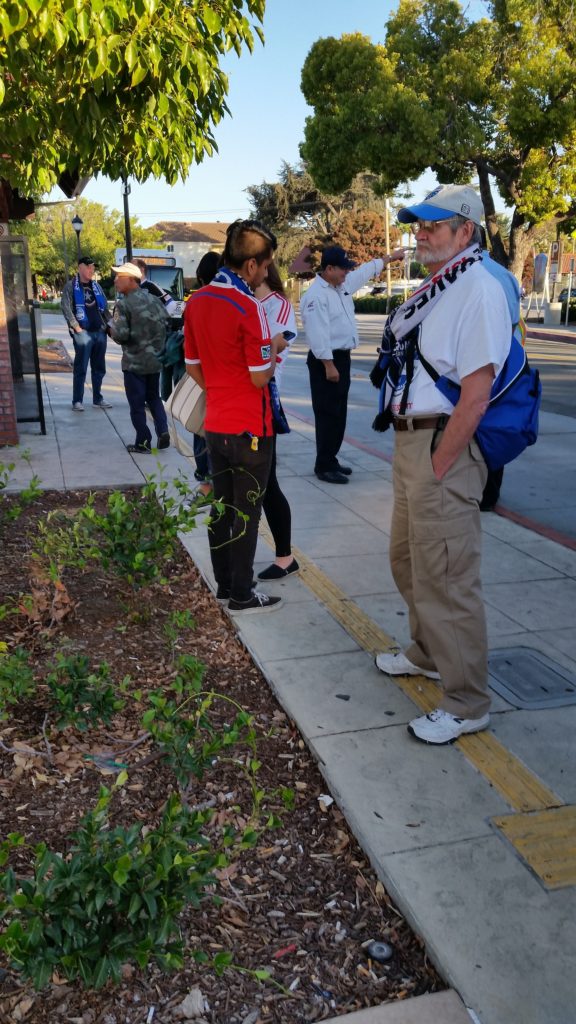 Soccer fans waiting for a VTA bus to the soccer match.