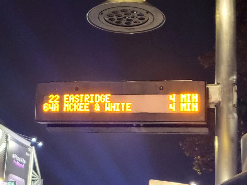 VTA real-time bus arrival sign in San Jose. 
Shown on yellow text w/ black background:
22 EASTRIDGE 4 MIN.
64A MCKEE & WHITE 4 MIN.